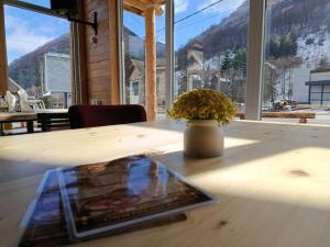 a book on a table with a vase on it at Etno kuca Brzece in Brzeće