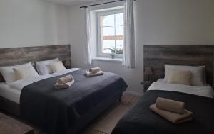 a bedroom with two beds with towels on them at apartmány TASIA in Mýto pod Ďumbierom