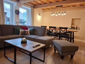 a living room with a couch and a table at apartmány TASIA in Mýto pod Ďumbierom
