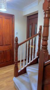 a wooden staircase in a house with a wooden door at 40 Kennett gardens in Gloucester