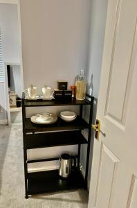 a black cart with plates and utensils on it at 40 Kennett gardens in Gloucester