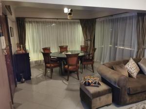 a living room with a couch and a table and chairs at Adham's Inn in Cairo