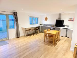 a kitchen and dining room with a table and chairs at Poplar holiday cottage in Moulton Chapel