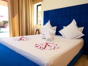 a bedroom with a blue and white bed with towels at Villa des iris Domaines NAJMA in Marrakesh +33 photos