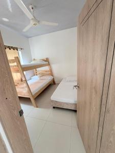 a room with two bunk beds and a door at Casa WHITE in Melgar