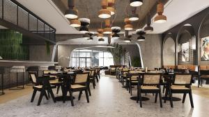 a restaurant with tables and chairs in a room at Three Corners Hotel in Skopje