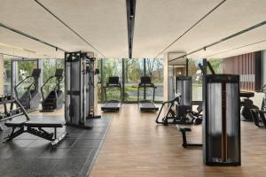 a gym with several treadmills and exercise bikes at Sheraton Suzhou Yangcheng Lake in Suzhou
