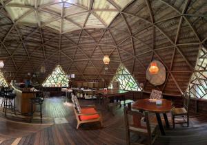 a large room with tables and chairs in a building at Palmayacu - Refugio Amazónico in Leticia +63 photos