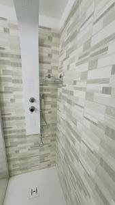 a bathroom with a shower with a stone wall at Ca Rolina in Camagna Monferrato +10 photos