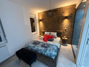 a bedroom with a bed with red apples on it at Apartman North in Mladenovac