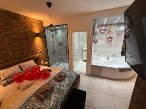 a bathroom with a bed and a bath tub and a sink at Apartman North in Mladenovac +20 photos