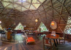 a large room with tables and chairs in a building at Palmayacu - Refugio Amazónico in Leticia