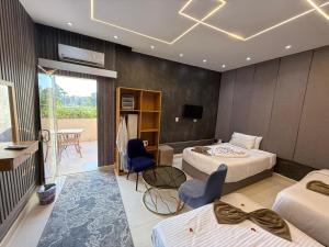 a hotel room with two beds and a television at Glow Pyramids View Hotel in Cairo