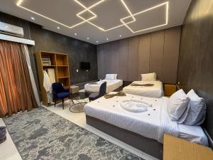 a hotel room with two beds and a table at Glow Pyramids View Hotel in Cairo +89 photos