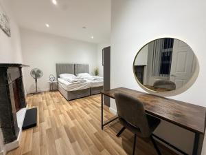 a room with a desk and a mirror and a bed at MK Apartments, Chorlton, Manchester Car Park in Manchester