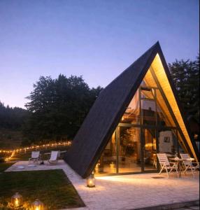 a modern house with a black triangular roof at Spa villas Higo in Žabljak