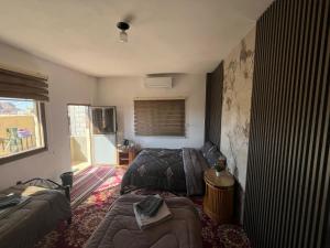 a living room with a couch and a bed at Eman house in Wadi Musa