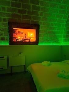 a bedroom with a fireplace in a brick wall at AyUR Emotional Suite in Spinazzola +30 photos