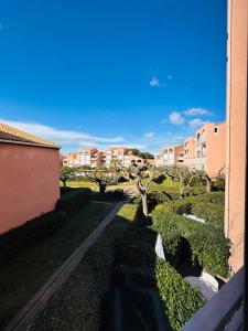 a view from a balcony of a yard with buildings at Les Soleillades-T2 pour 5 pers-piscine, parking privé- LaConciergerieByNina in Palavas-les-Flots