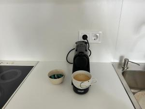 a coffee maker on a counter with a cup of coffee at Anna Coast Apartment in Agia Anna