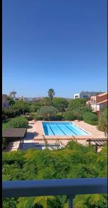 a view of a swimming pool from a balcony at Les Soleillades-T2 pour 5 pers-piscine, parking privé- LaConciergerieByNina in Palavas-les-Flots +5 photos