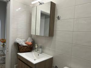 a bathroom with a sink and a mirror at Anna Coast Apartment in Agia Anna