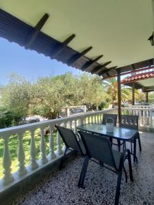 a patio with a table and chairs on a balcony at O&A By the Sea in Polychrono
