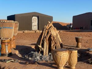 a group of boots and other items in the desert at Tarrast Desert Camp in Mhamid +3 photos