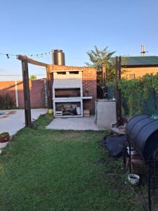 a backyard with a grill in the grass at Nuestro refugio in Roldán