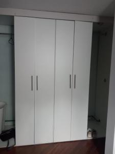 a pair of white cabinets in a room at SUITE CUMBAYA Junto Reservorio in Quito