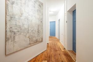 a hallway with a large painting on the wall at City apartment - small but nice in Gera +2 photos