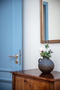 a vase with flowers on a table in front of a door at City apartment - small but nice in Gera