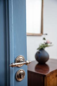 a door with a metal door knob and a vase at City apartment - small but nice in Gera