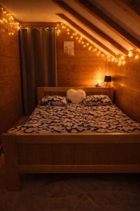a bedroom with a bed with lights on it at Kuća za odmor Kiara in Kolarec