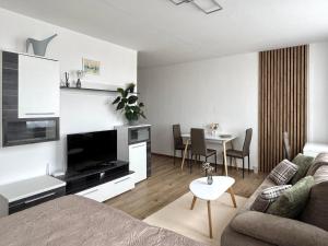a living room with a couch and a table at Smarty Choice Living with FREE PARKING - Vondroušova in Prague +58 photos