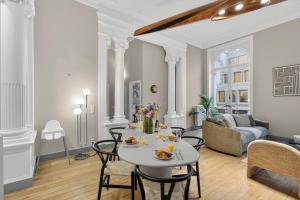 a living room with a table and chairs at Maison Lombard by Reside in Brussels