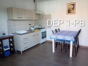 a kitchen with a table and a small table and a table and a tableablish at Alquituc Escobar in Belén de Escobar
