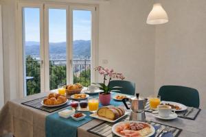a breakfast table with breakfast foods and orange juice at Il Sogno in Como