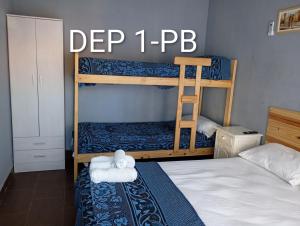 a bedroom with two bunk beds with a ladder at Alquituc Escobar in Belén de Escobar