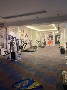a gym with several tread machines in a room at Condo in Alramal near to the airport in Riyadh +2 photos