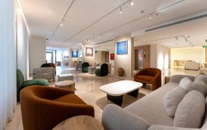 a living room with a couch and chairs and tables at فندق آفال AVAL Hotel in Medina +47 photos