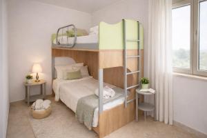 a bedroom with two bunk beds and a window at SicilyNice in Avola