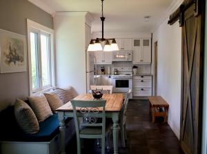 a kitchen with a table and chairs in a room at Cute and cozy 3 bedroom apartment centrally located in Moncton