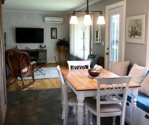 a living room with a wooden table and chairs at Cute and cozy 3 bedroom apartment centrally located in Moncton