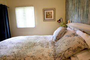 a bedroom with a bed and a window at Cute and cozy 3 bedroom apartment centrally located in Moncton