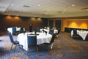 a conference room with tables and chairs and a podium at Courtyard by Marriott Battle Creek in Battle Creek