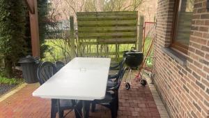 a white table and chairs on a patio at Appartement chic bien situé in Mons