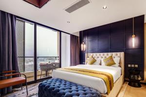 a bedroom with a large bed and a large window at April Hotel in Aqaba +77 photos