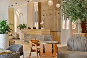 a lobby with chairs and tables in a store at The First Collection Waterfront, Dubai, a Tribute Portfolio Hotel in Dubai