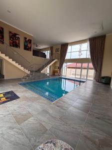a swimming pool in a house with a staircase at Hyalus House in Vaal Marina